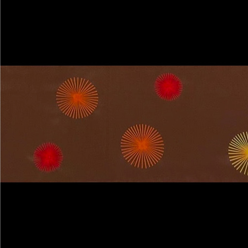 Table runner in colorful sunburst design on brown background . Approx 73x13"